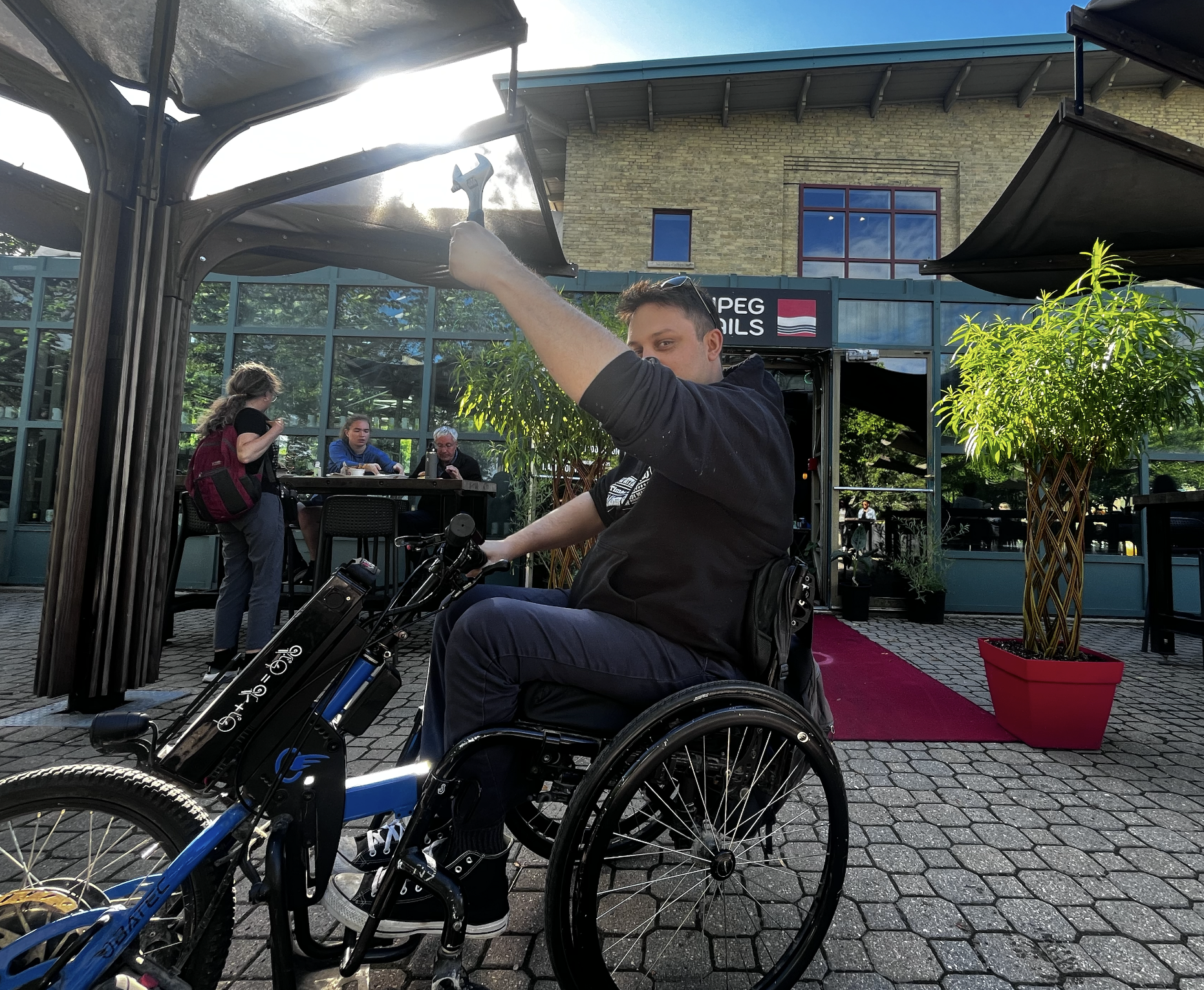 peter warkentin holding up a wrench