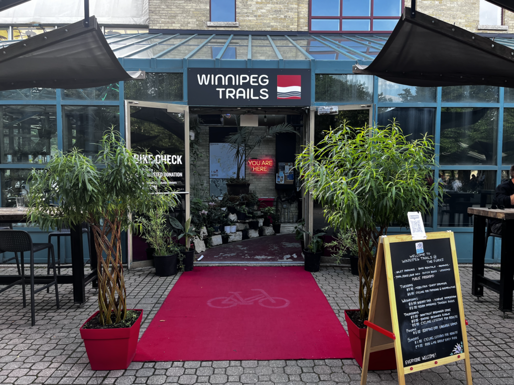 image showing the entrance to the winnipeg trails location at the forks, with a red carpet and lots of tropical plants